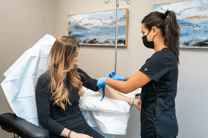 A clinician providing IV therapy to a patient