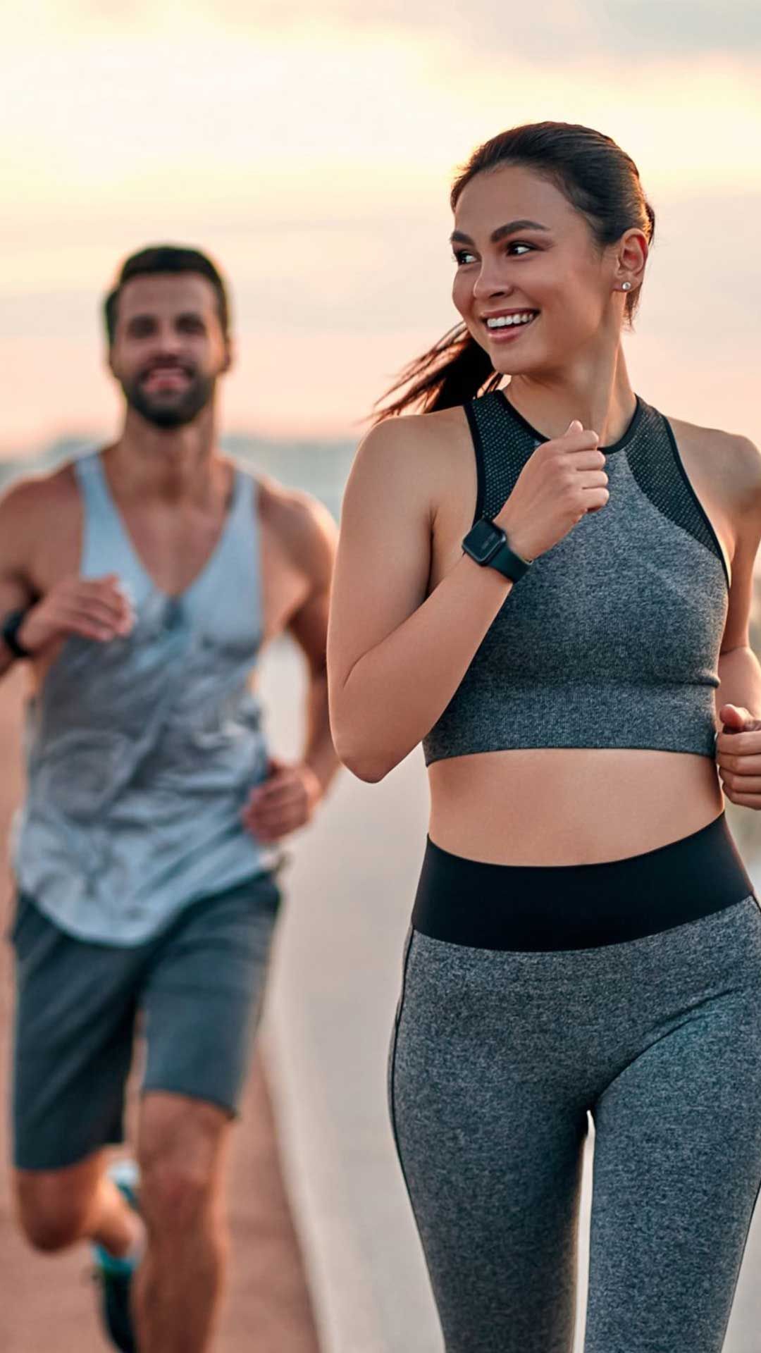 A woman and man running outdoors